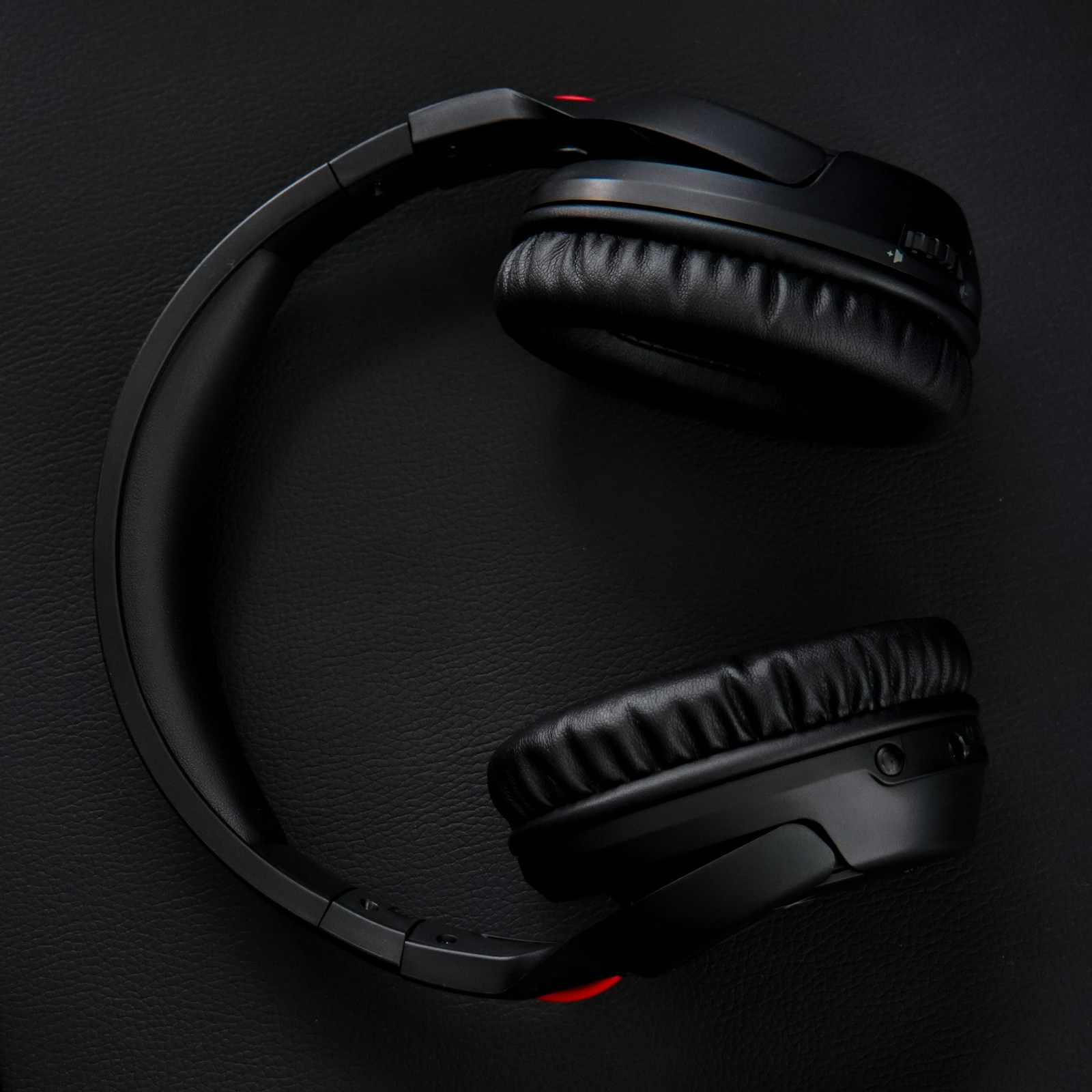 Black over-ear headphones on a dark surface