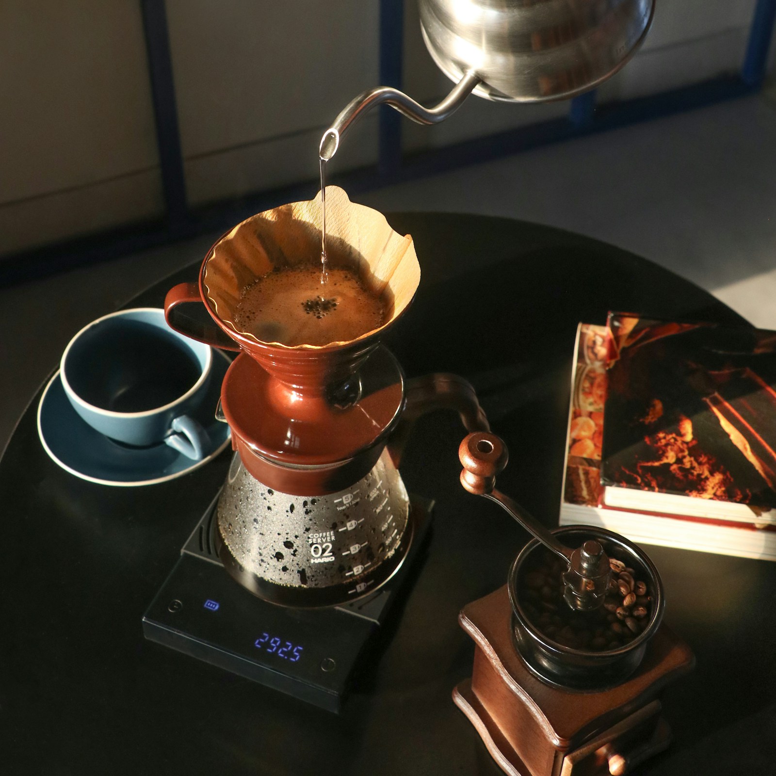 Coffee being poured over a filter on a kitchen scale