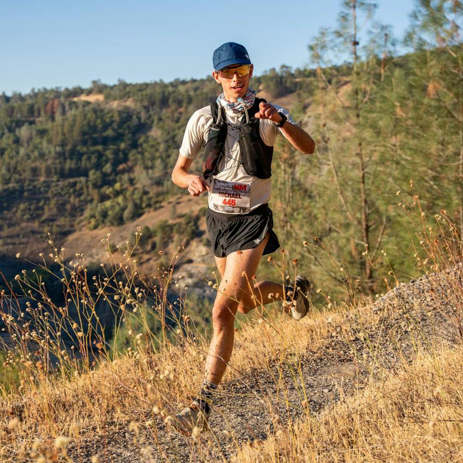 A trail runner on a dry hillside path
